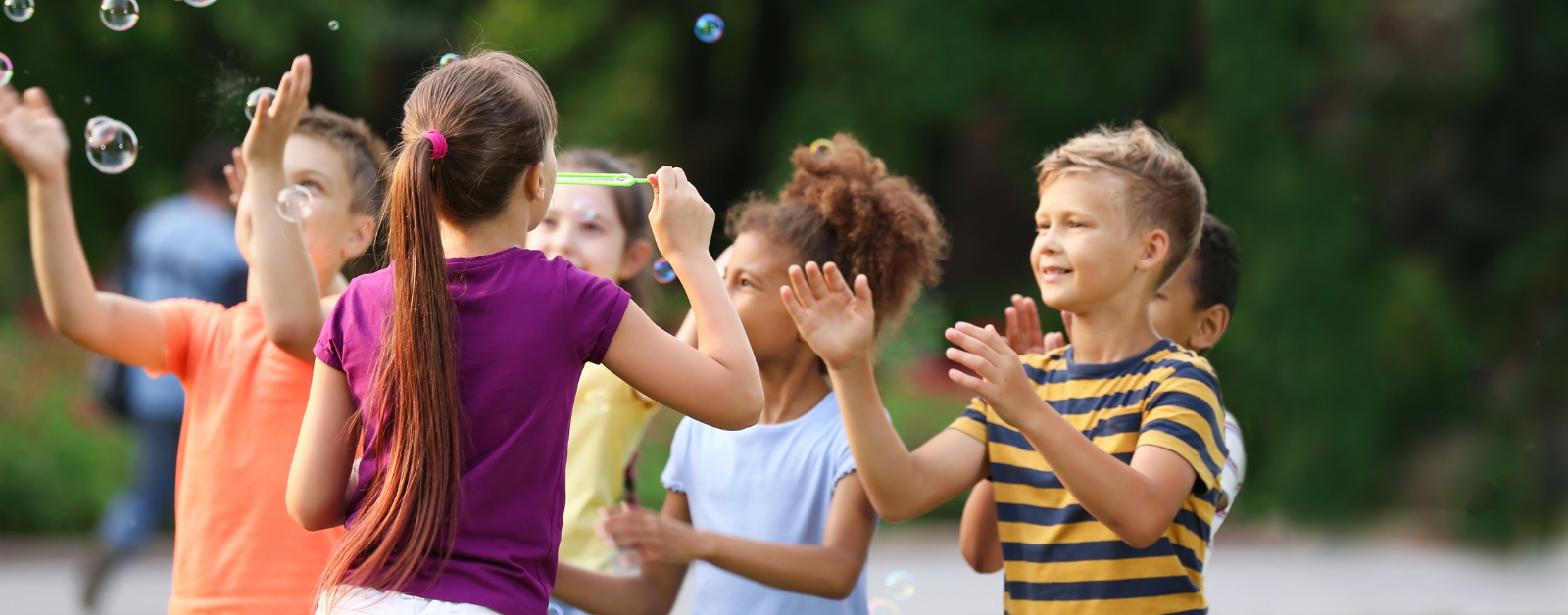 kids play outside with bubbles