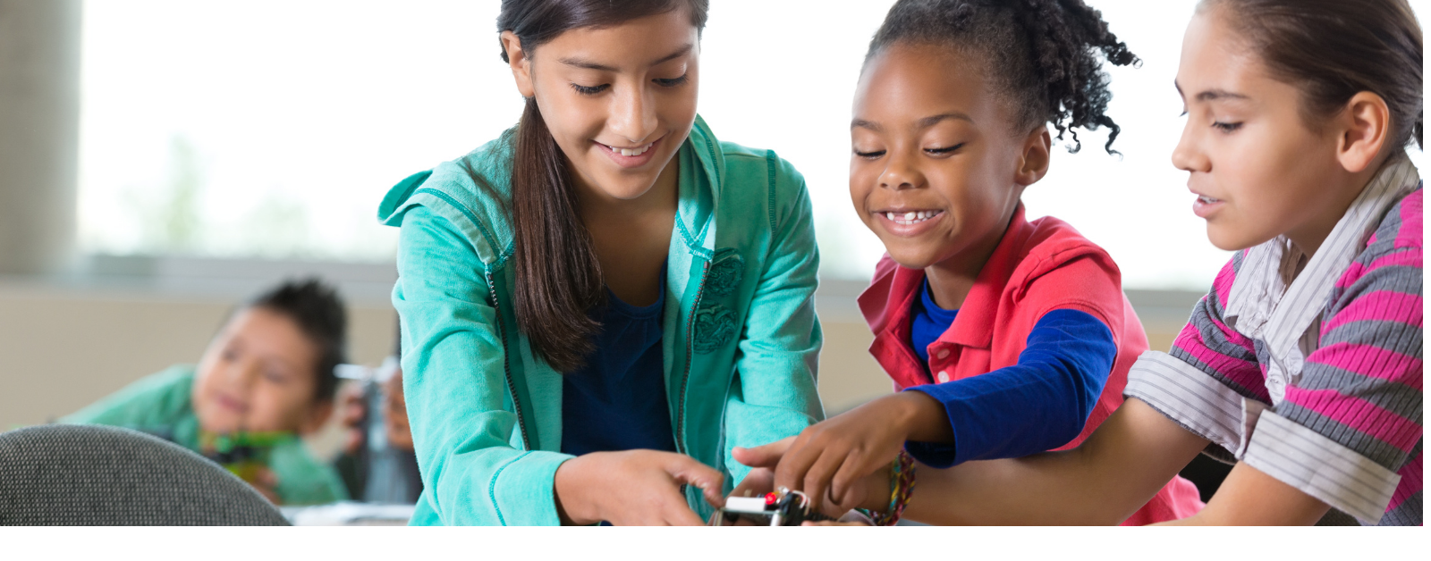 several girls of varying ages collaborate on a project together