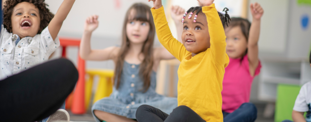 pre-school children stretch in morning circle time